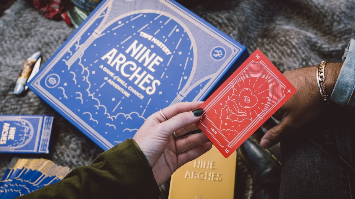 A shot looking down at people playing the Nine Arches card game